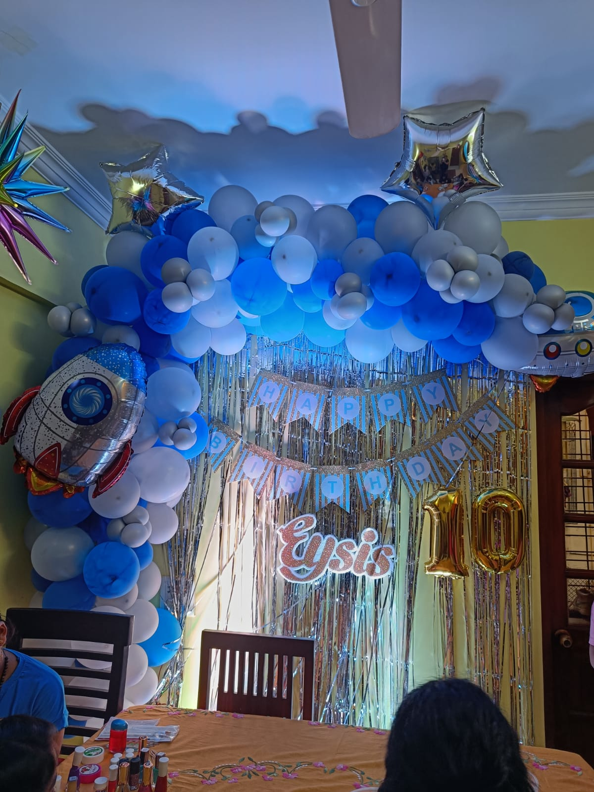 Birthday party with blue and white balloon arch and rocket theme